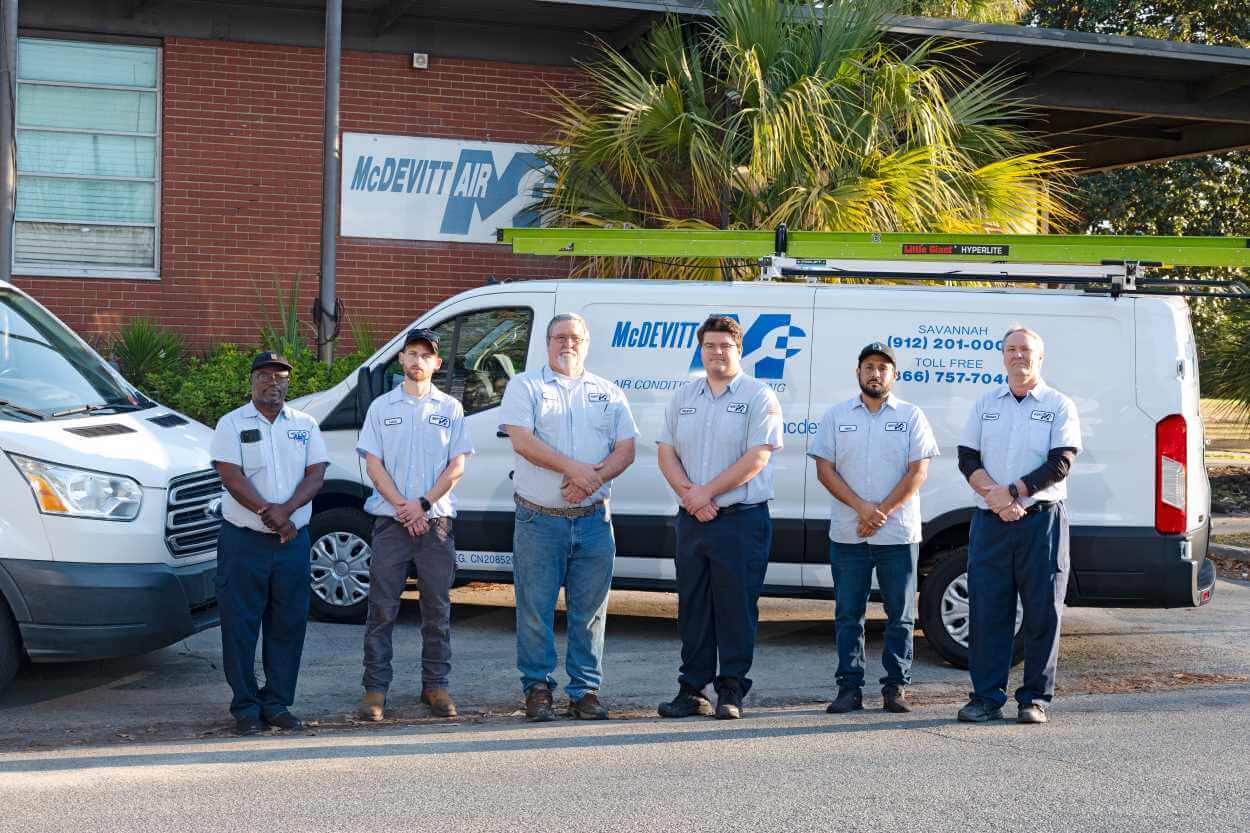 McDevitt Air employees in front of vans